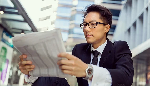 Business professional reading a newspaper